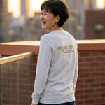 Person standing on a rooftop with cityscape in the background